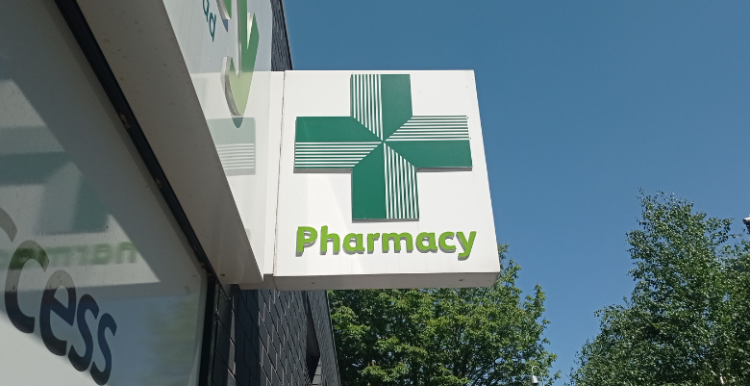 Image of a pharmacy sign with a green cross