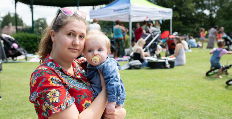 A lady holding her baby.