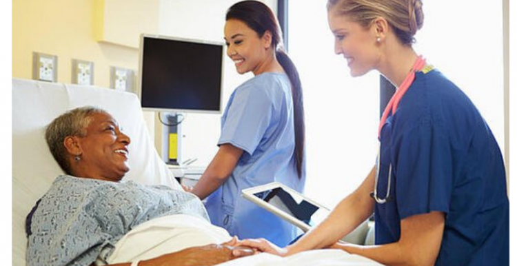 woman_in_bed_with_two_nurses_nearby