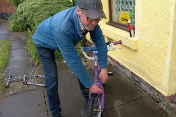 Man fixing a bike outside