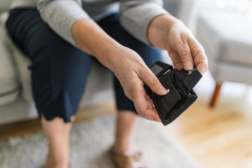 Image of a person's hands opening an empty purse