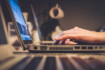 A person typing on a laptop